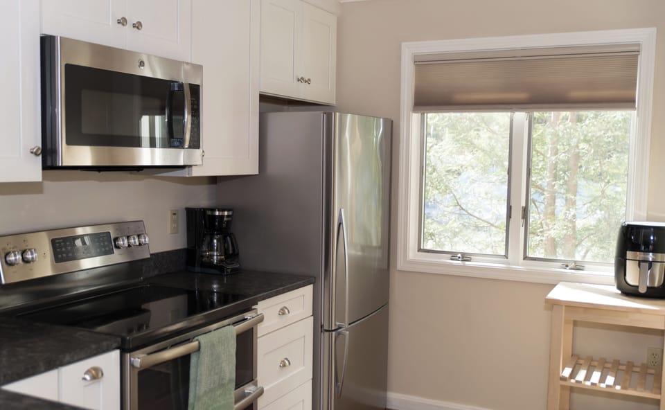  The kitchen features amenities like a dishwasher,  air fryer and coffee maker.