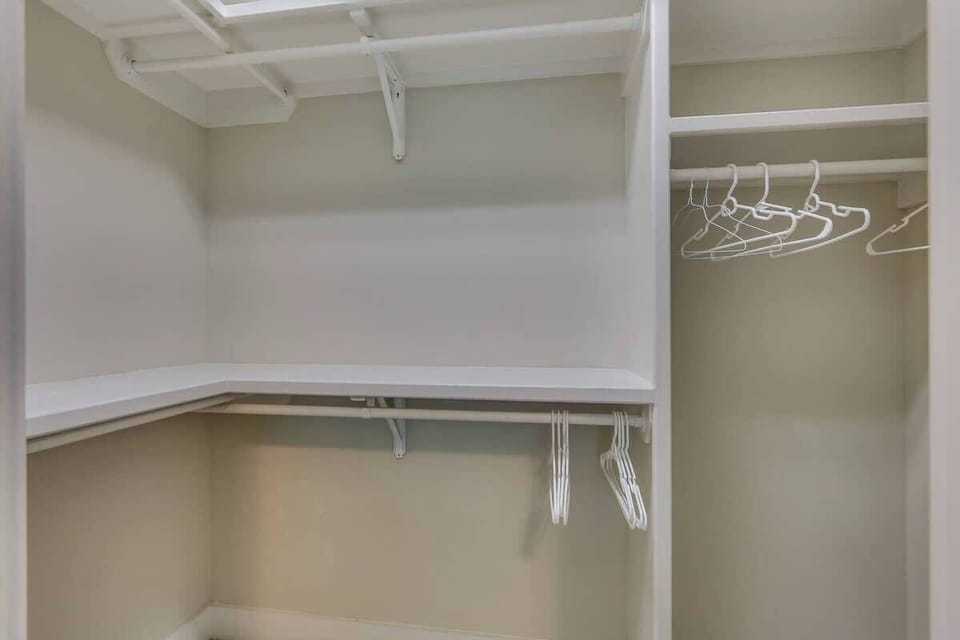 A spacious walk-in closet, perfect for all your luggage and storage needs.
