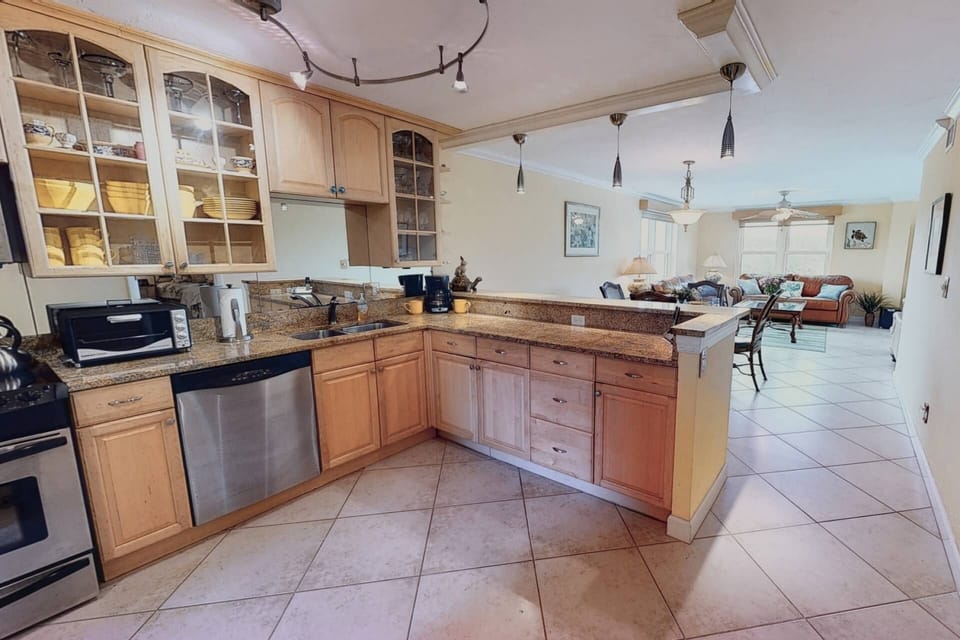 Large updated kitchen with granite and stainless steel appliances.