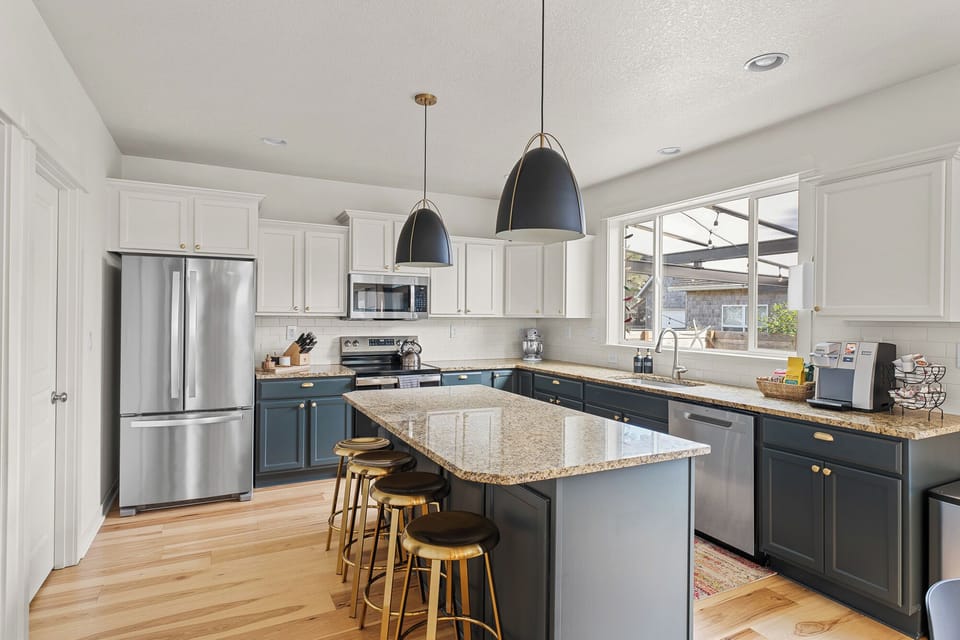 Revamped kitchen featuring state-of-the-art appliances and additional seating. 