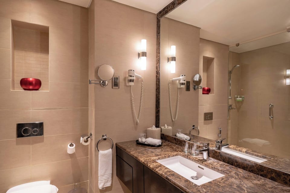 Jetted tub, rainfall showerhead, designer toiletries, hair dryer