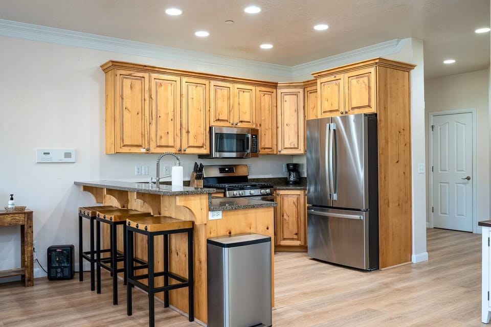 Prepare meals with ease using the provided knife set, coffee maker, double sink, and a selection of kitchen utensils, ensuring a seamless cooking experience during your stay.