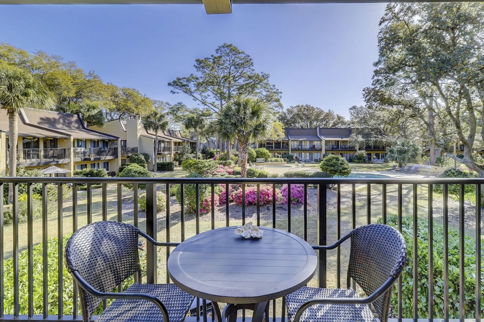 Balcony off kitchen overlooks pool and slight oceanview