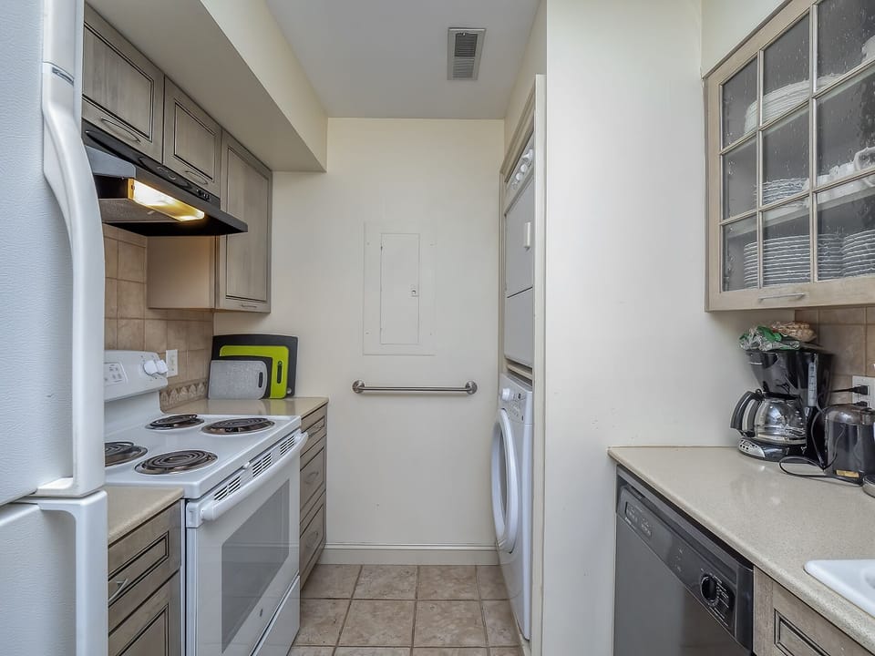 The stacked washer and dryer are just off the kitchen.