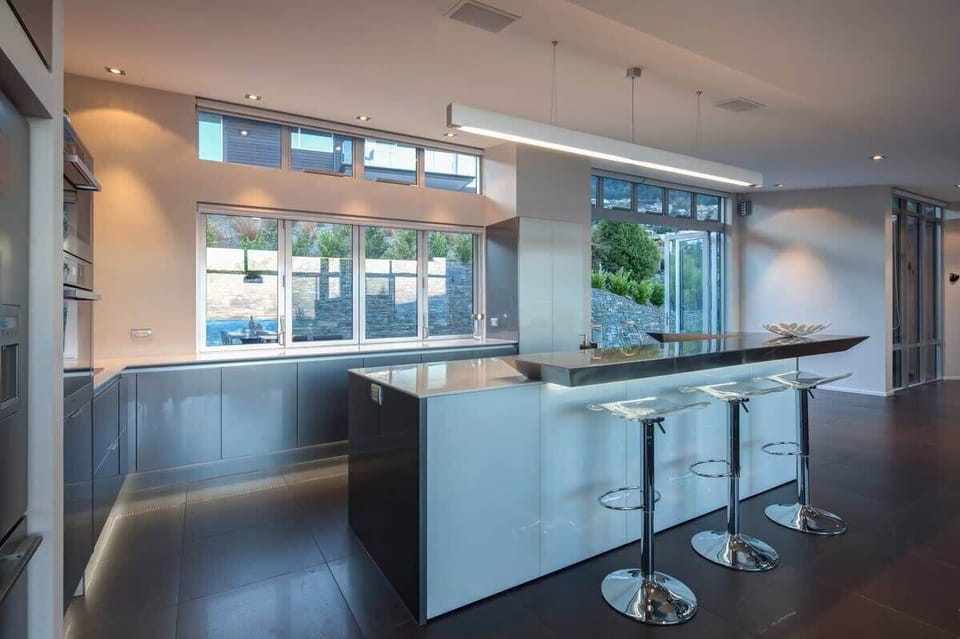 Kitchen featuring a large bench and bar top in our self-contained accommodation, Queenstown