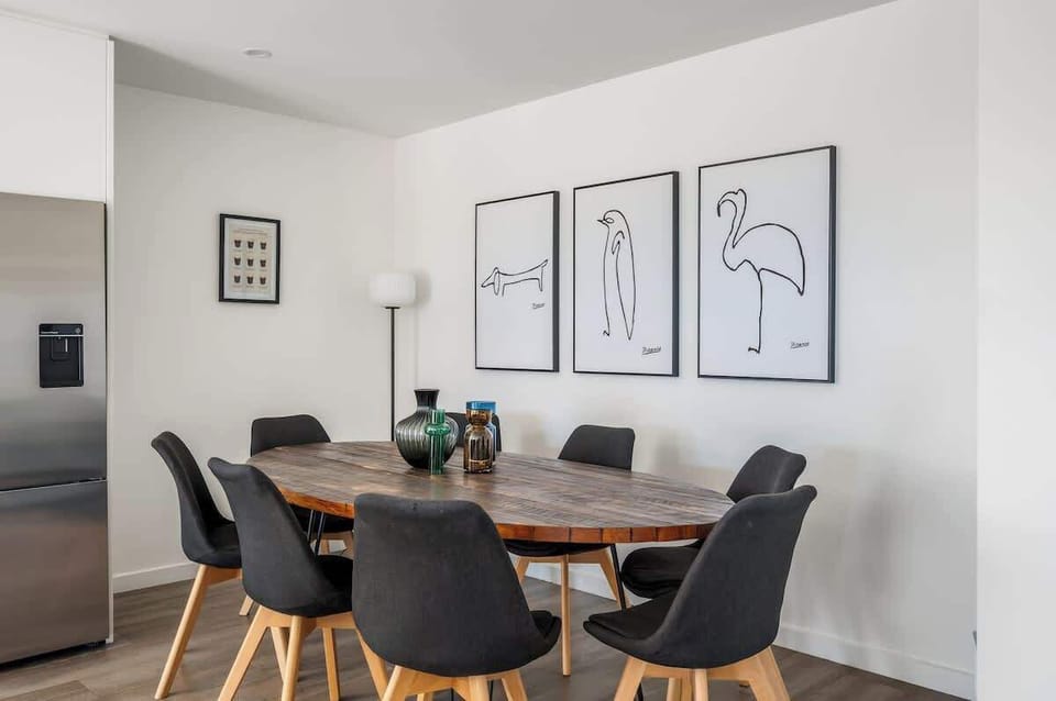 Gather around the dining table with lake and mountain views—perfect for shared meals and Queenstown holiday memories.