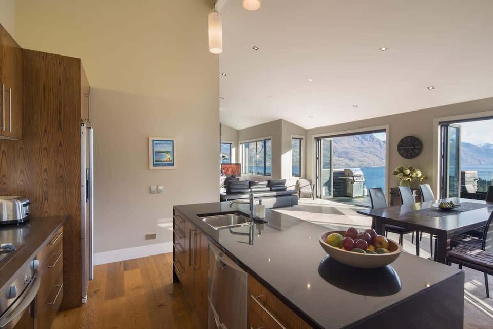 Modern Kitchen with a View: Cook in style while gazing out at the stunning lake and mountain scenery through expansive windows.