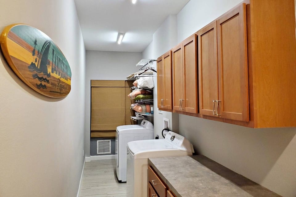 Laundry room downstairs. There is door next to laundry room that leads out to the backyard.