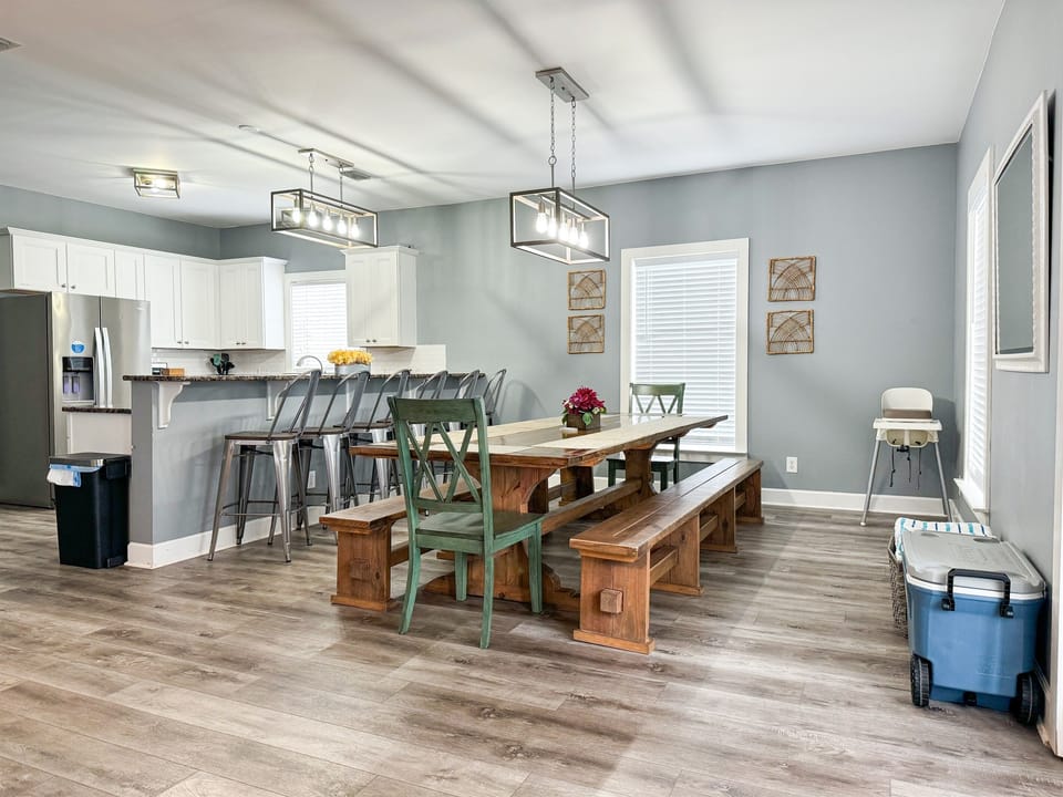 Large, custom-made dining table to accommodate your group with additional seating at the counter.  Note the high chair and the cooler for your convenience. Not many homes allow the whole gang to be together like this floorpan does!