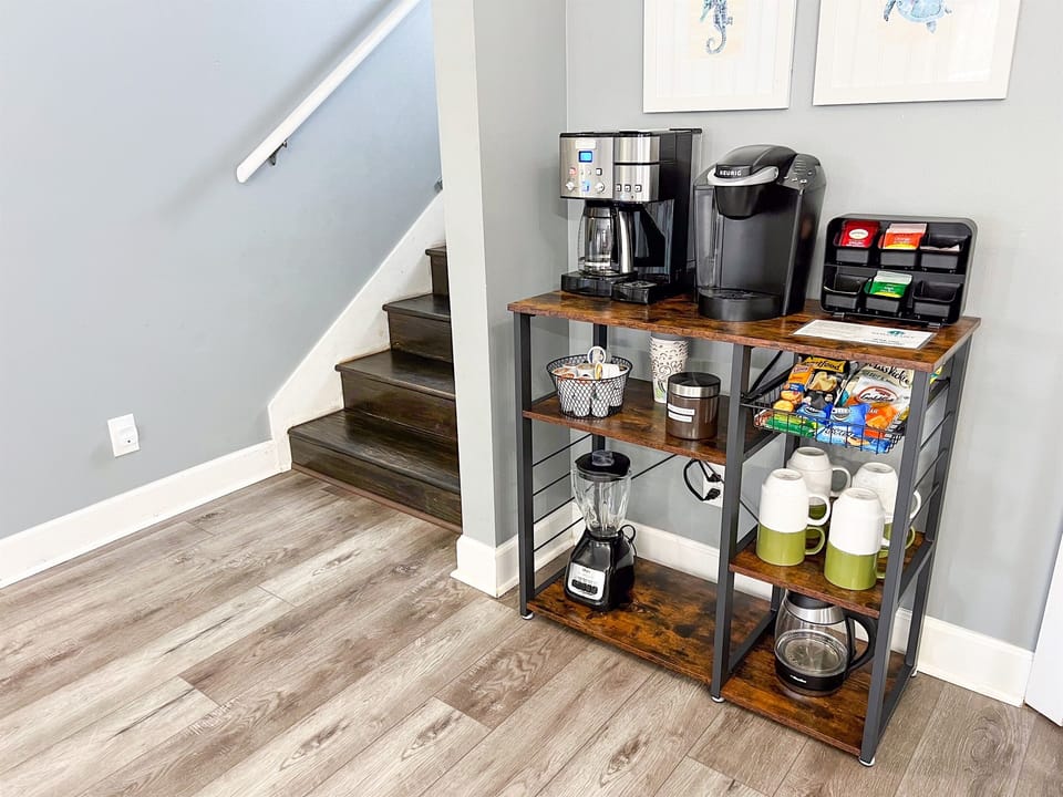 Nicely outfitted coffee bar with 2 k-cup machines, drip brewer w/filters, electric tea kettle, blender, and more!