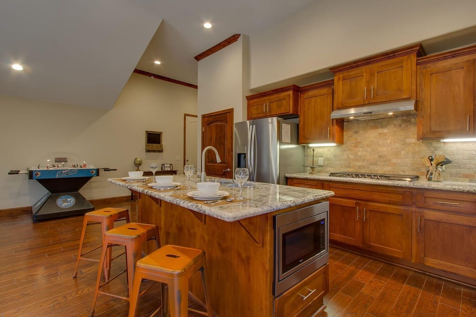 - Spacious kitchen with granite countertops  
- Stainless steel appliances and ample storage  
- Arcade hockey game adds fun to the space