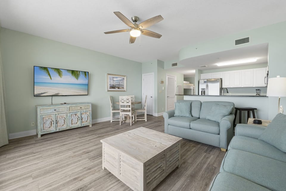 Open living and dining area with a coastal decor, and an easy flow into the fully equipped kitchen.