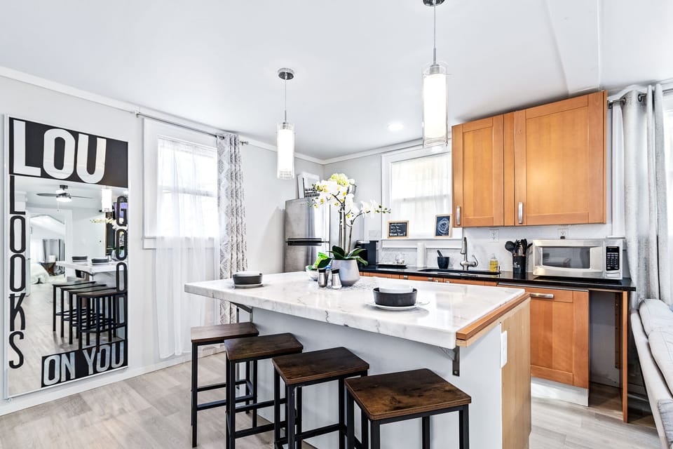 Dine in marble island with full refrigerator and dishwasher available.