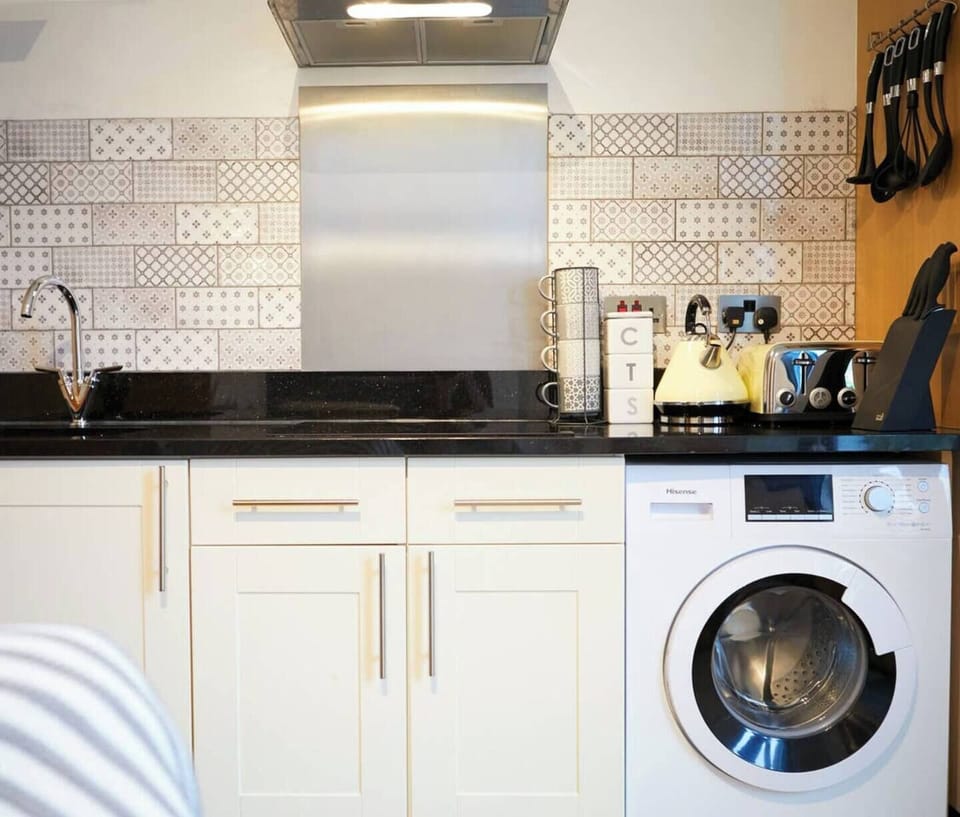 Well equipped Kitchen. It has an oven, electric hob, microwave, fridge and freezer, toaster, kettle, washer, full set of kitchen ware, dining ware.
