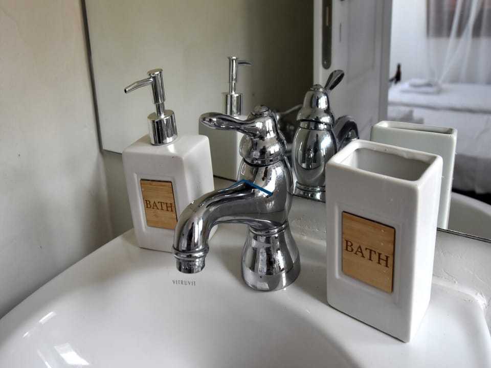 The en-suite bathroom on the 1st floor . The shower is hand held, no enclosure