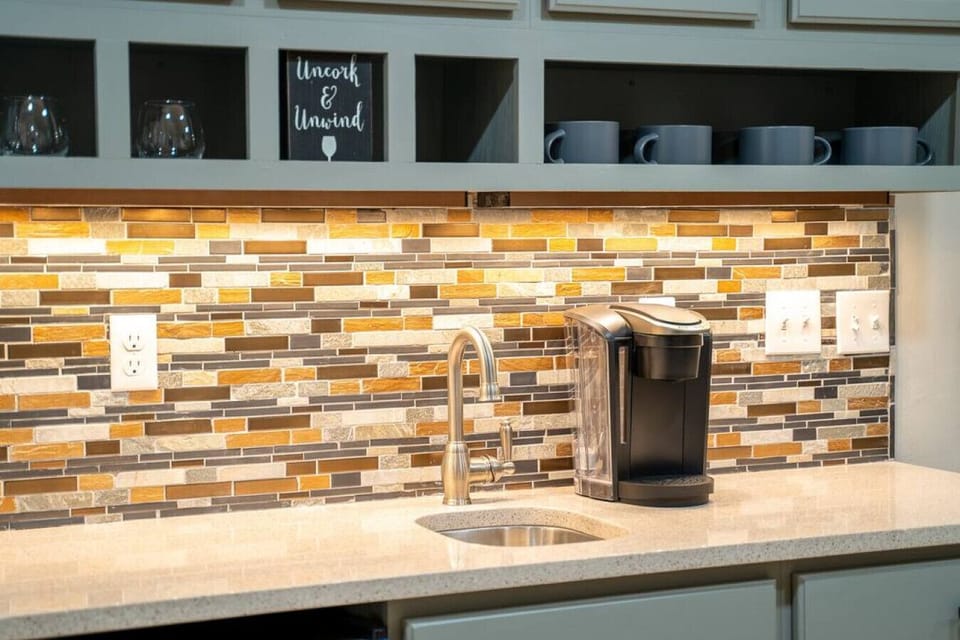 The wet bar is stocked with water, tea, and coffee.