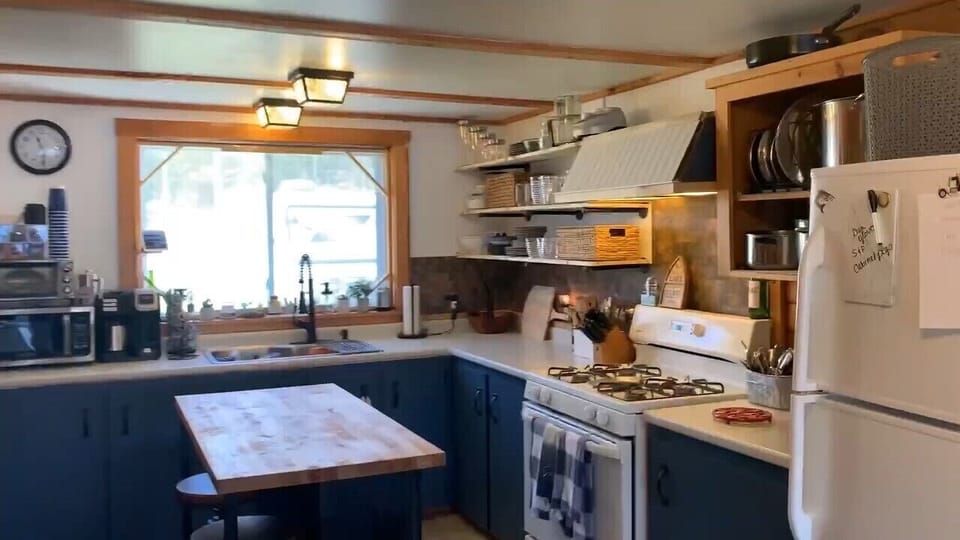 Well appointed kitchen with two stool island and a coffee station