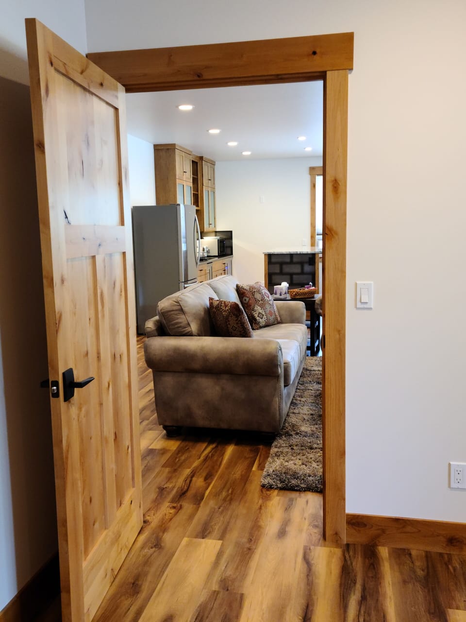 Looking out bedroom to living room and kitchen.