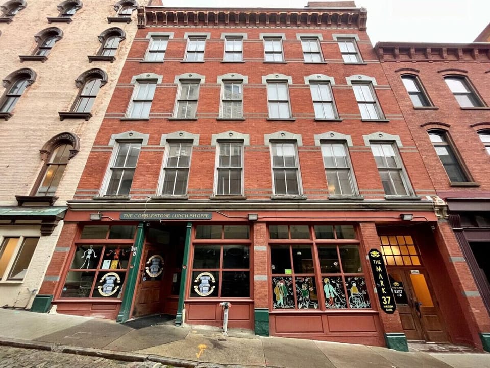 Welcome to The Mark on Maiden! Front Entrance facing North Pearl Street! Cobblestone Lunch Shoppe Deli on the ground floor. Residential entrance to the right (next to the The Mark 37 Maiden Lane sign).