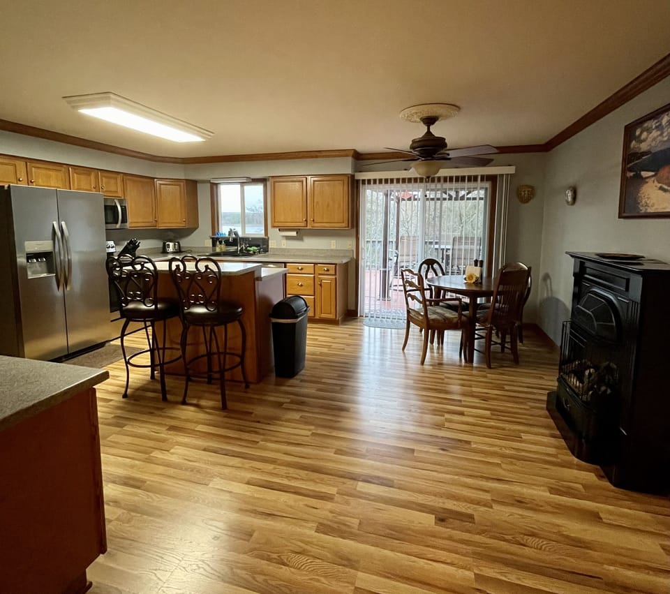 Kitchen with glass doors to deck, dinette and island.