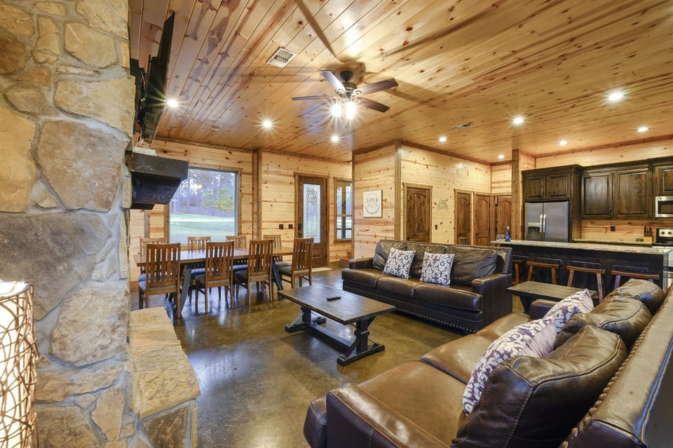 This airy living room invites you to enjoy comfort and style, with large windows that bring the beauty of nature indoors.
