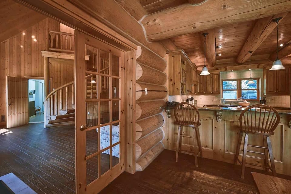 Open-plan kitchen and dining with custom log details and great lighting