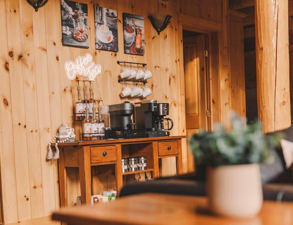 Coffee and tea corner with a warm wooden backdrop and decorative art