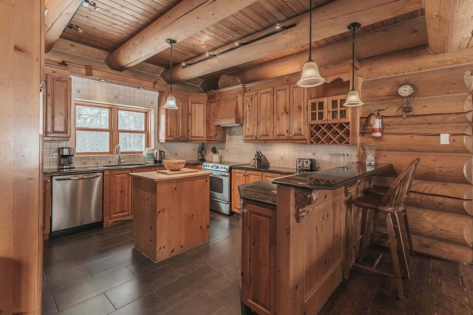 Modern kitchen with wood cabinets, stainless steel appliances, and natural light