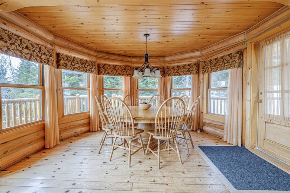 Dining nook surrounded by windows offering views of the outdoors