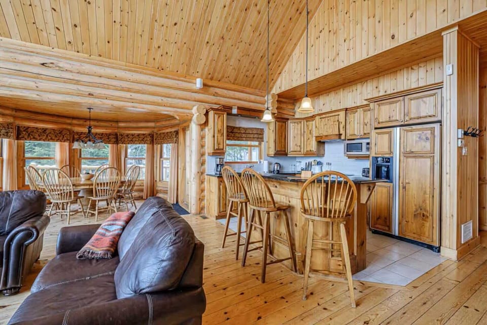 Kitchen and dining area with wooden cabinetry and bar seating