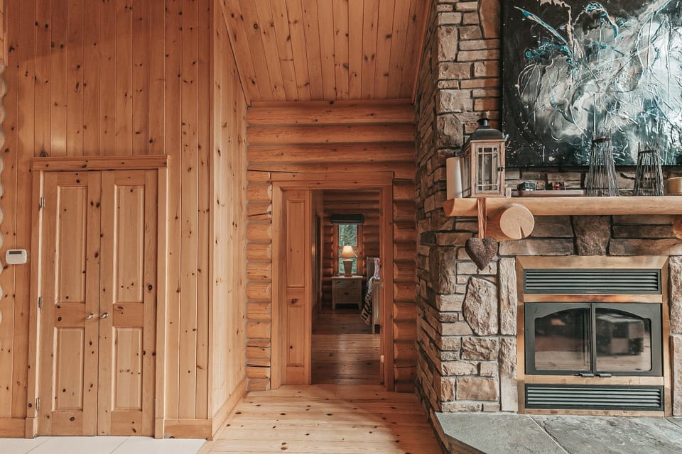 Hallway with wooden floors and log cabin-style walls