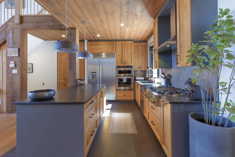 Fully equipped gourmet kitchen with high-end appliances and wood detailing