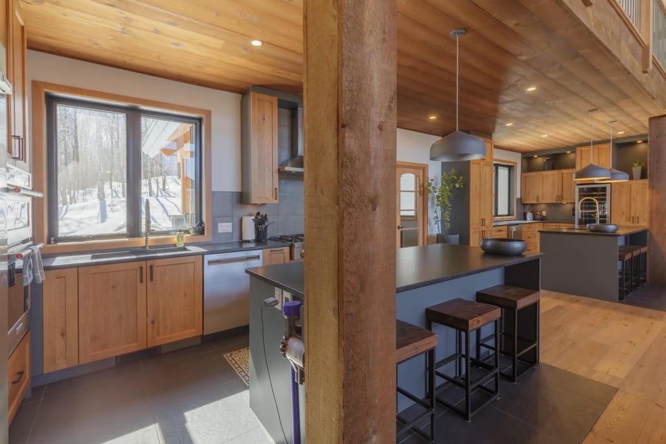 Bright kitchen with island seating and rustic beams for a warm atmosphere