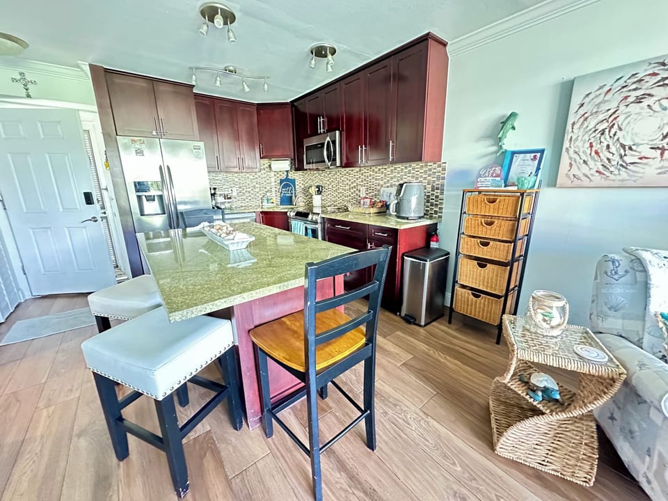Fully stocked kitchen for all your culinary needs , and open dining area.
