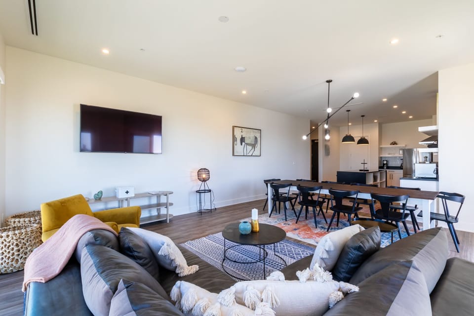 Living room with a luxurious leather couch, TV and views from every angle of the room.