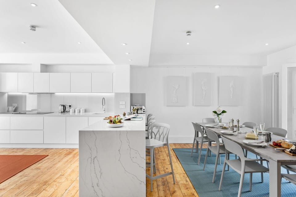Quartz surfaces, original Victorian floor boards, and bespoke artworks.