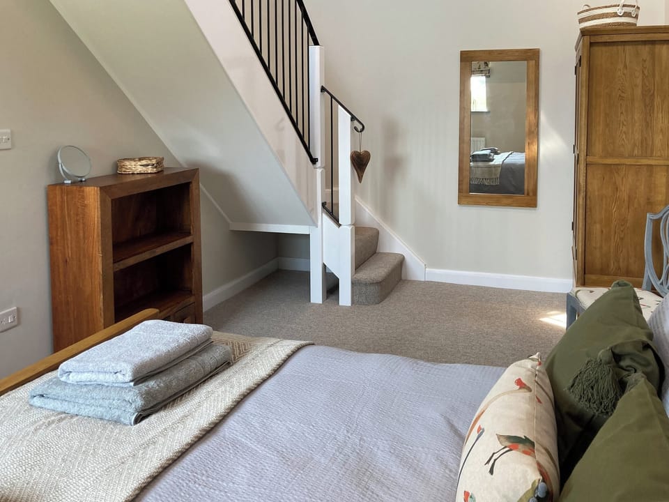 Double bedroom with access stairs to mezzanine | Tadpole Mews at Frog Hall, Tilston, near Malpas