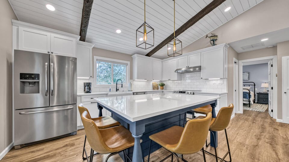 Open concept dining area next to the screened in Florida porch with dining area for 10 under beautiful string lights and palm deco ceiling fans. (second floor)