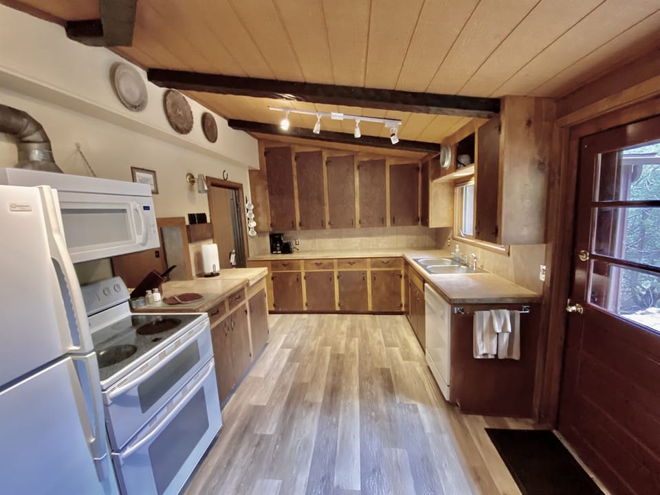 Kitchen with backdoor to propane grill, picnic table, and washer/dryer