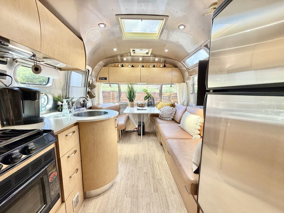 The airstream offers everything you need to feel right at home. With plenty of seating, convenient kitchen amenities, natural light and beautiful scenery out every window 