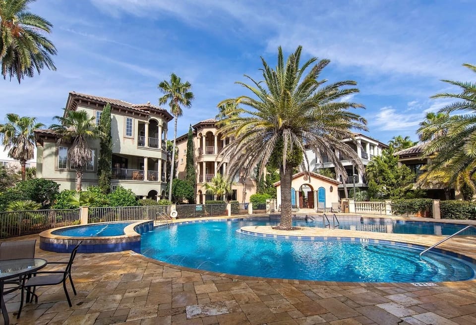 Large resort-style lagoon pool with sprinklers and oversized whirlpool hot tub