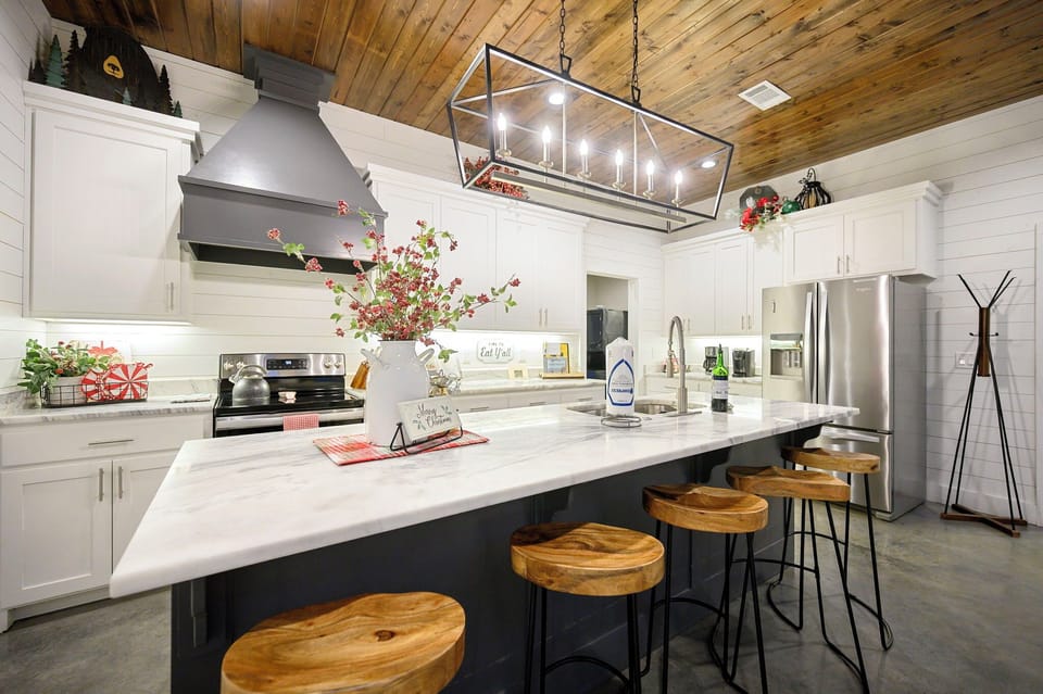 Your fully-equipped kitchen invites culinary adventures with its spacious island, modern appliances, and warm rustic charm.