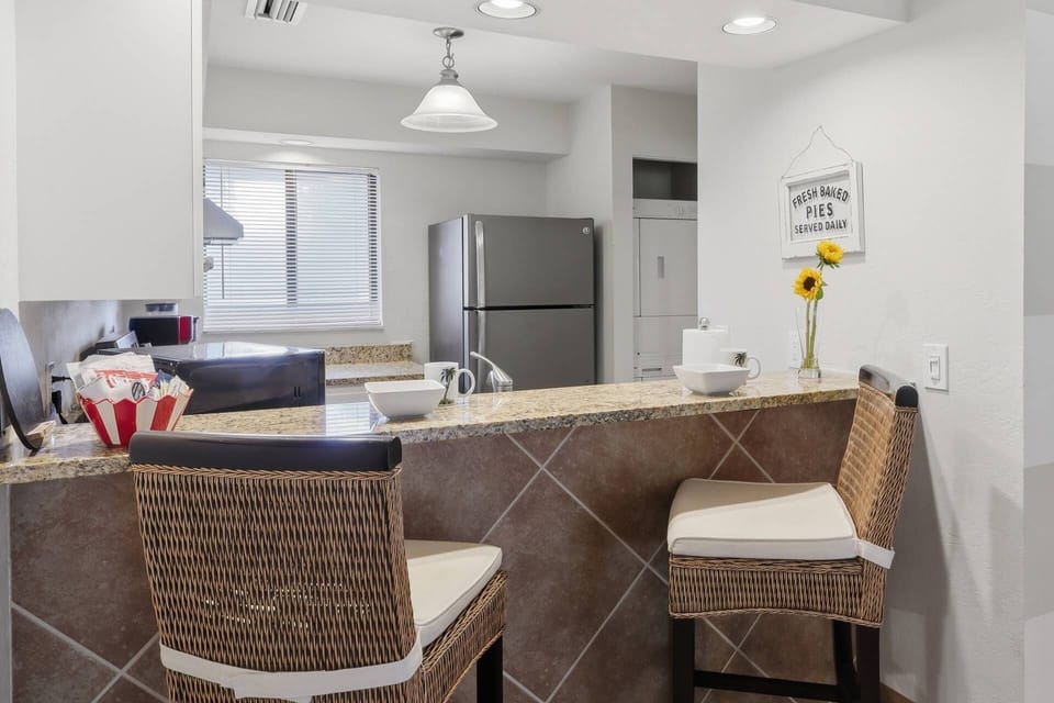 Breakfast bar seating and a fully equipped kitchen make dining in easy and convenient.