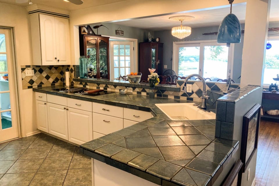 The gourmet kitchen overlooks the dining room and has great views of the water.