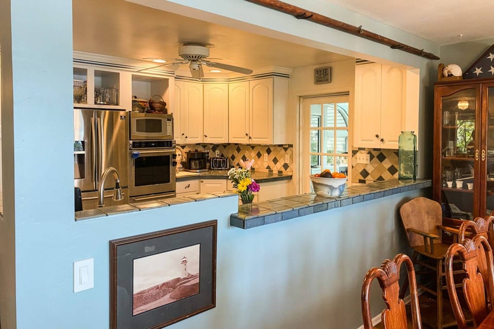 The bright gourmet kitchen opens up to the dining room.