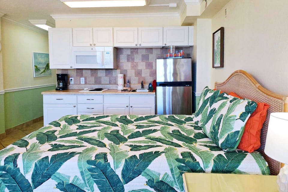 Refrigerator, microwave, new 2 burner stove, coffee maker, toaster oven, small crockpot, hand mixer, plates, utensils, etc.