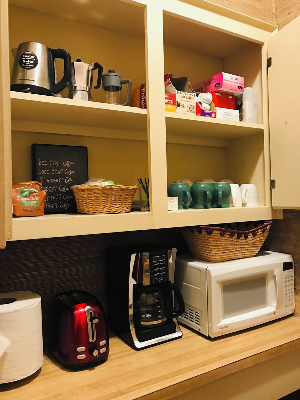 kitchenette with microwave, coffee maker and sandwich press.  
