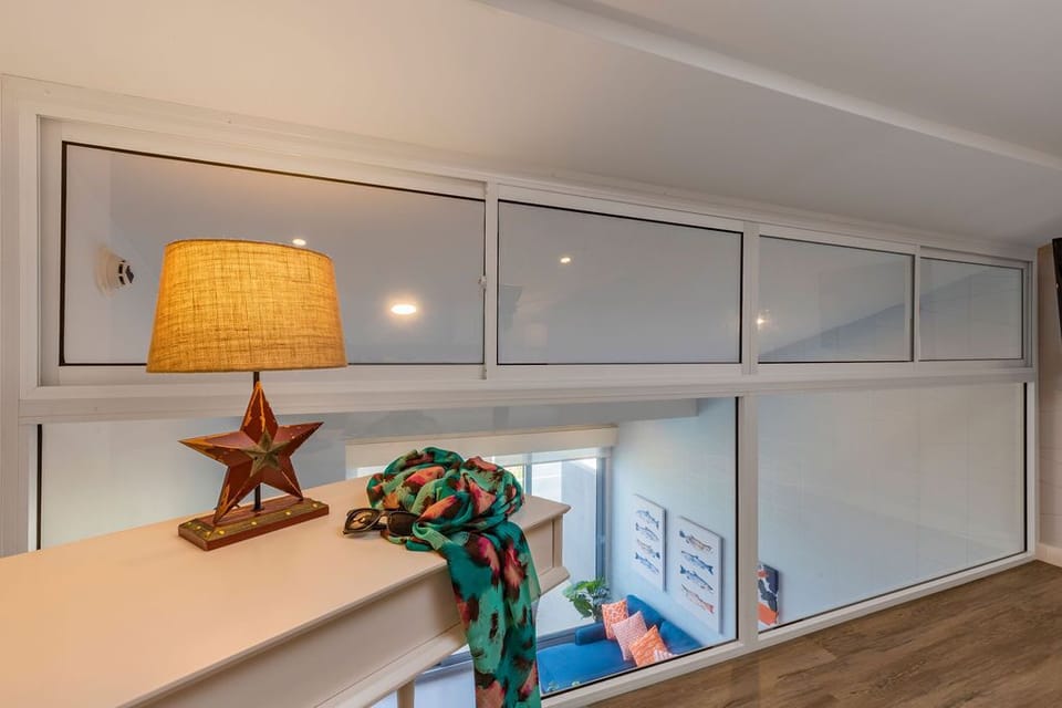Your loft bedroom offers clever storage and a cozy sleeping nook overlooking the living space below, perfect for families or groups seeking extra comfort.