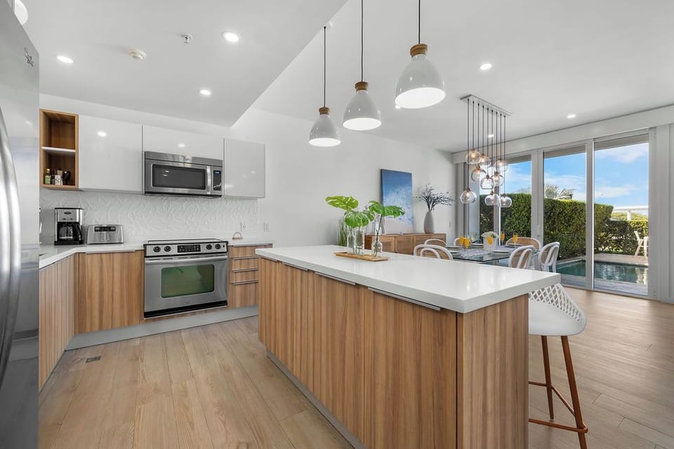 Your sleek kitchen features modern appliances and a spacious island perfect for morning coffee or casual meals.
