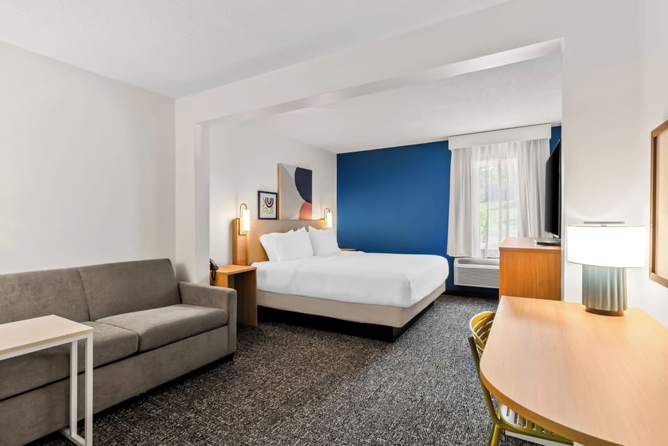 Desk, laptop workspace, iron/ironing board, free cribs/infant beds